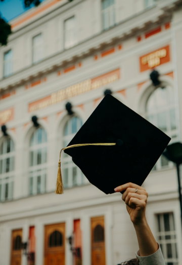 person-holding-black-academic-hat.jpg person holding black academic hat